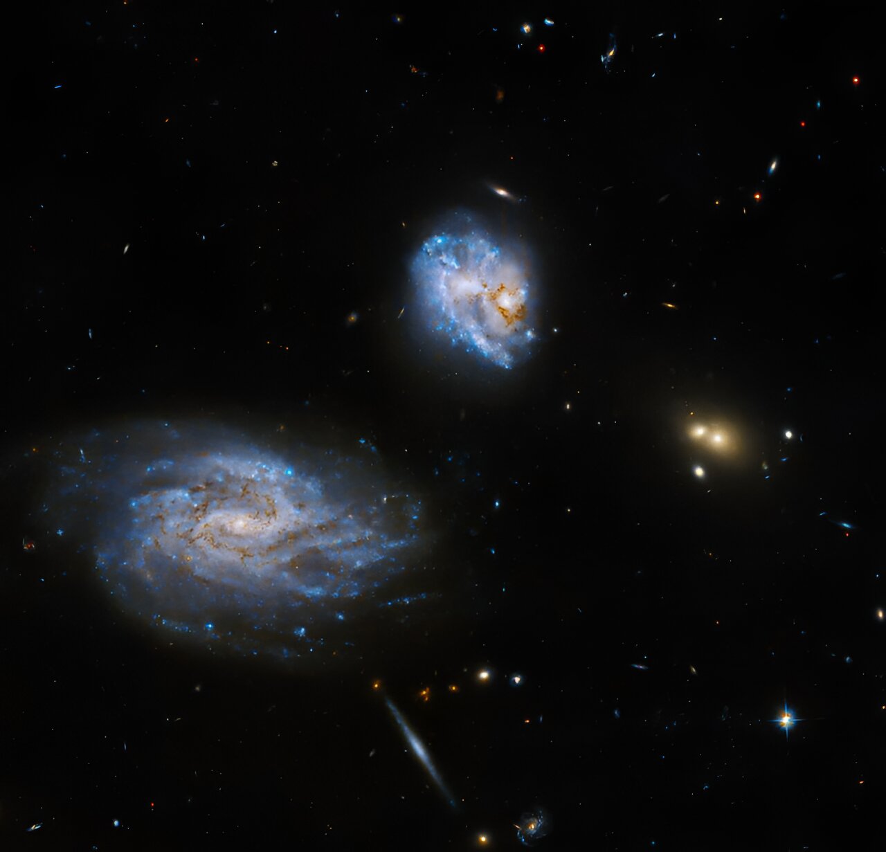 Hubble Observes a Tilted Galaxy Encouraging Star Formation in its Companion.