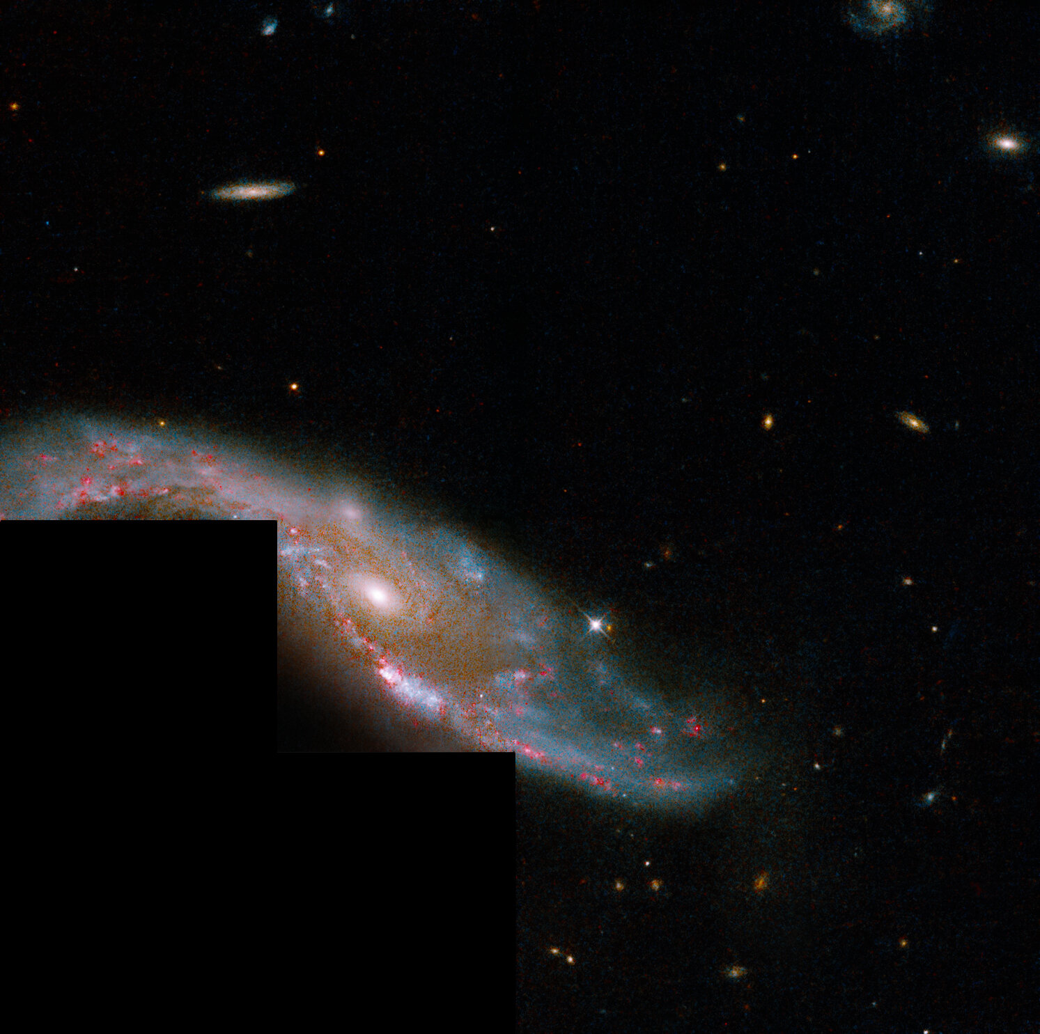The spiral galaxy is observed by the Hubble telescope in a state of interaction.