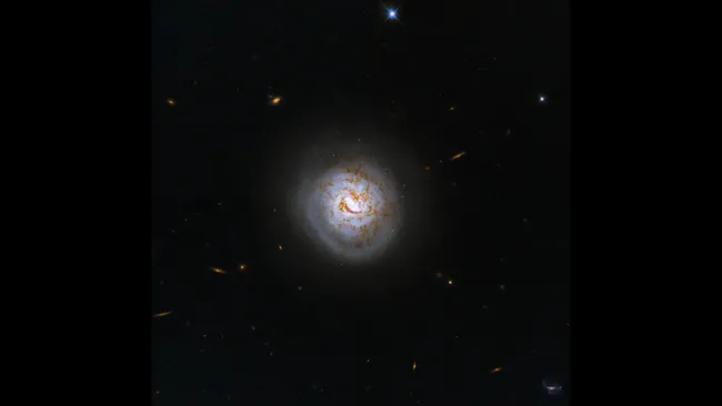 Weekly Space Snapshot: Hubble Captures a ‘Baseball Galaxy’ Featuring a Black Hole at its Core