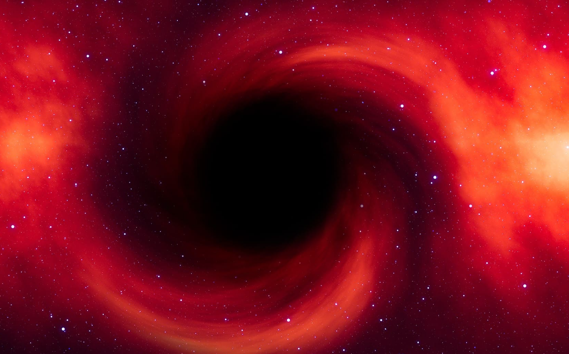 The JWST has identified a supermassive black hole that is rapidly growing in the early universe and appears to be extremely red.